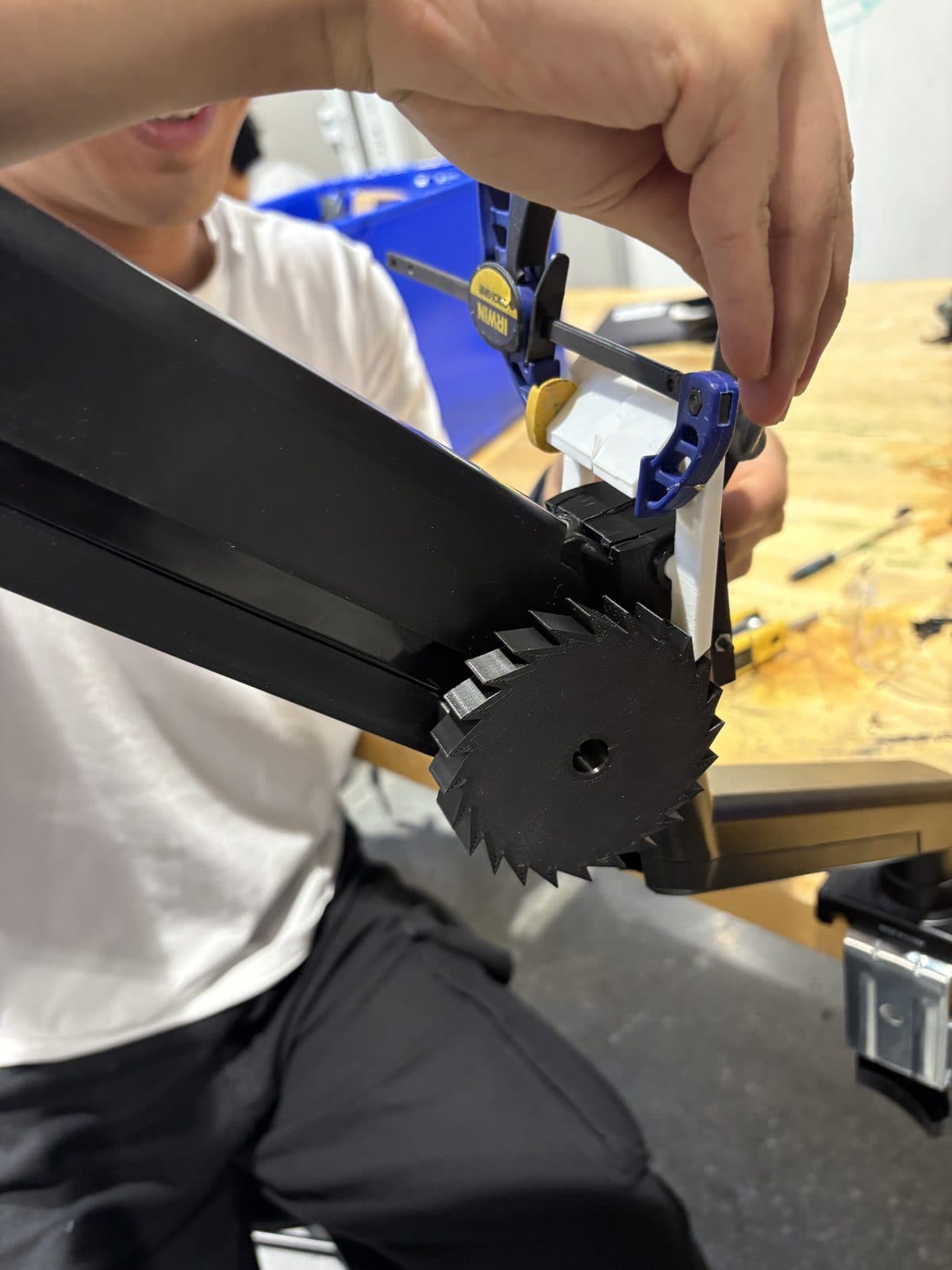 The gear and pawl mounted onto the commercial arm's joint.